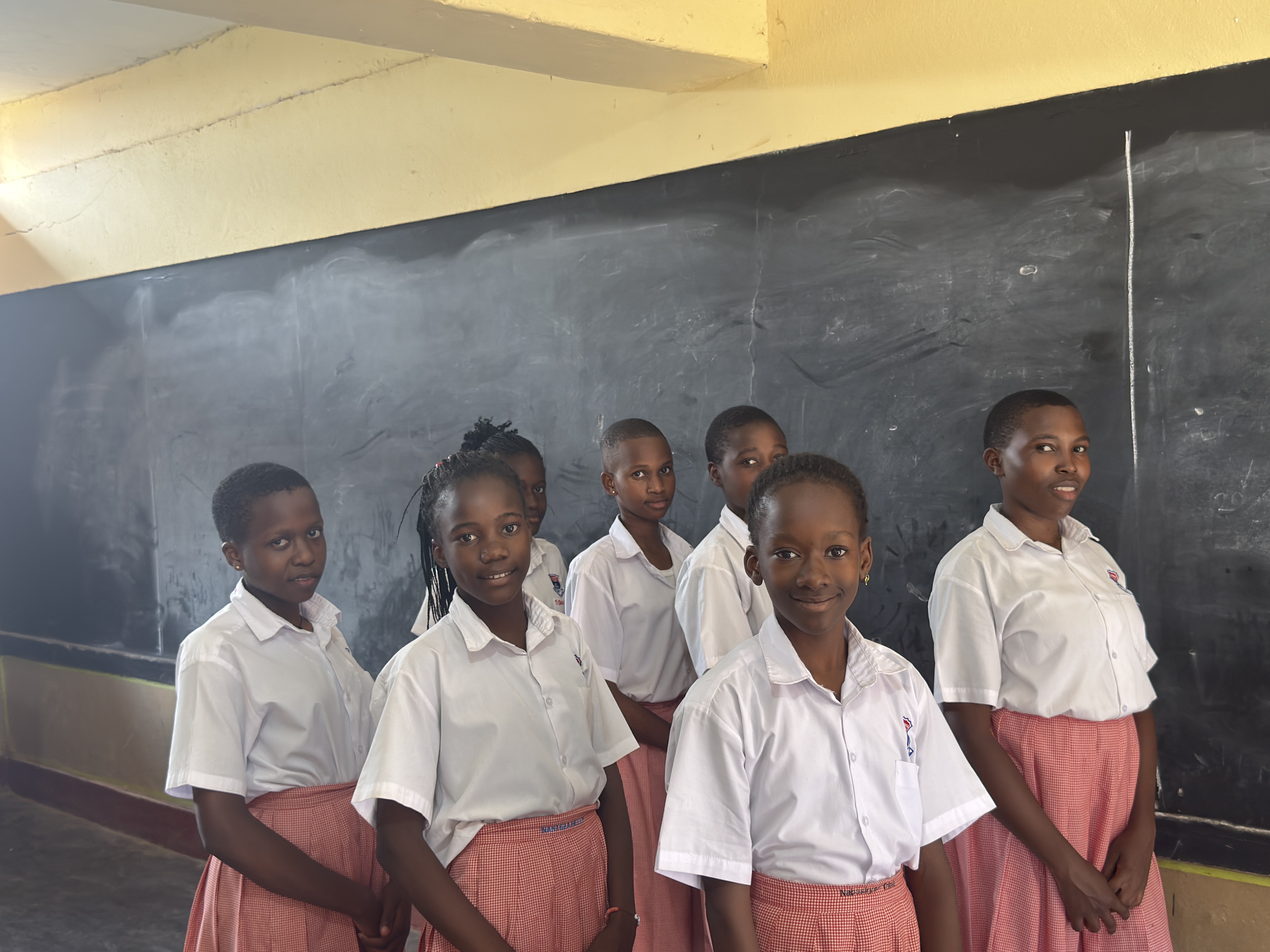 St. Lawrence Junior School Kabowa learner raising her hand confidently during class